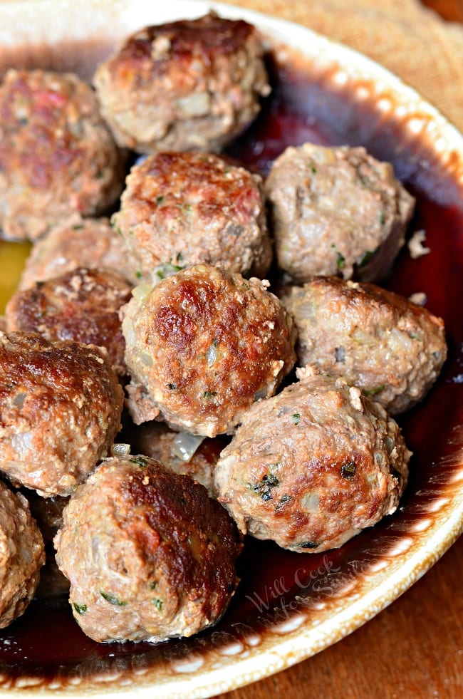 Cooked meatballs piled on a serving plate.