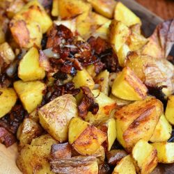cutting boared covered with brown roasted potatoes