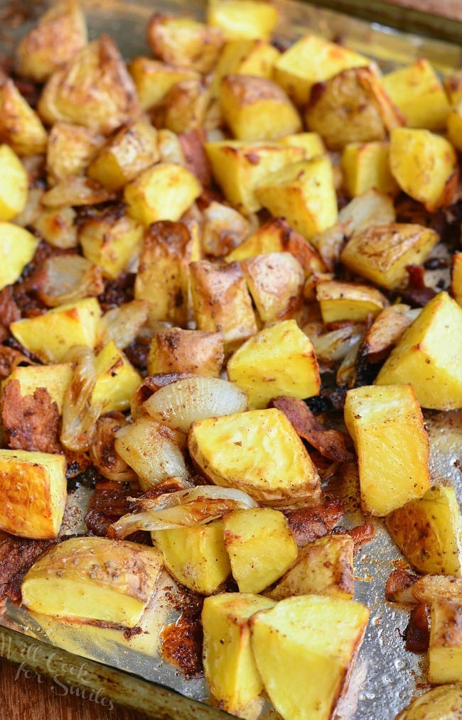 Roasted Potatoes with Bacon and Pearl Onions on a baking sheet