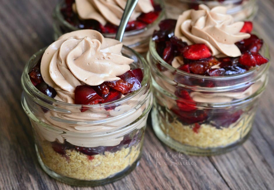 2 Chocolate Cherry Cheesecake Pie In A Jar with a spoon in one of them 