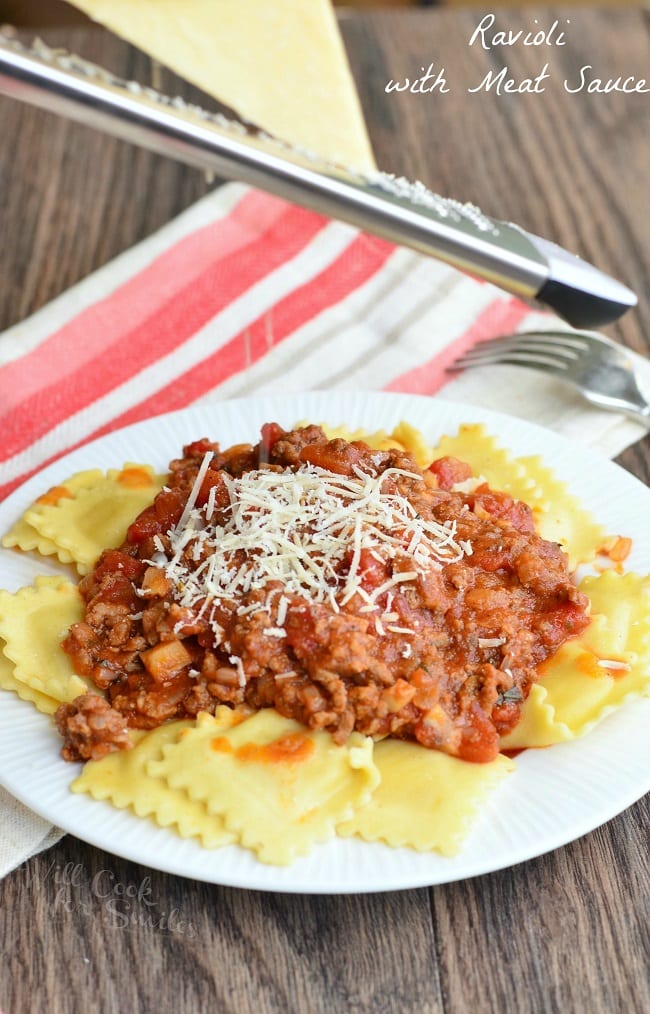 Ravioli with Meat Sauce with parmesan cheese on a white plate  