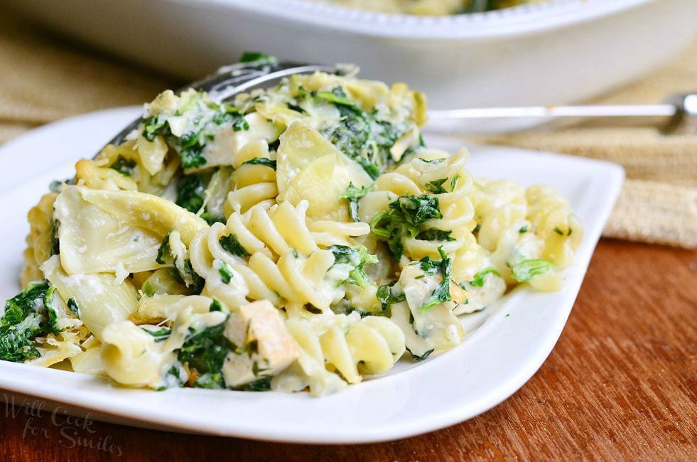 A serving of the Chicken Spinach and Artichoke Pasta Casserole on a white plate.