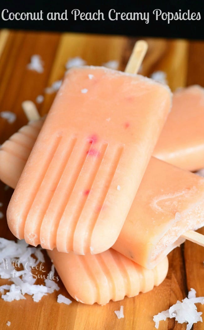 Coconut and Peach Creamy Fruit Ice Pops stacked up on a cutting board 