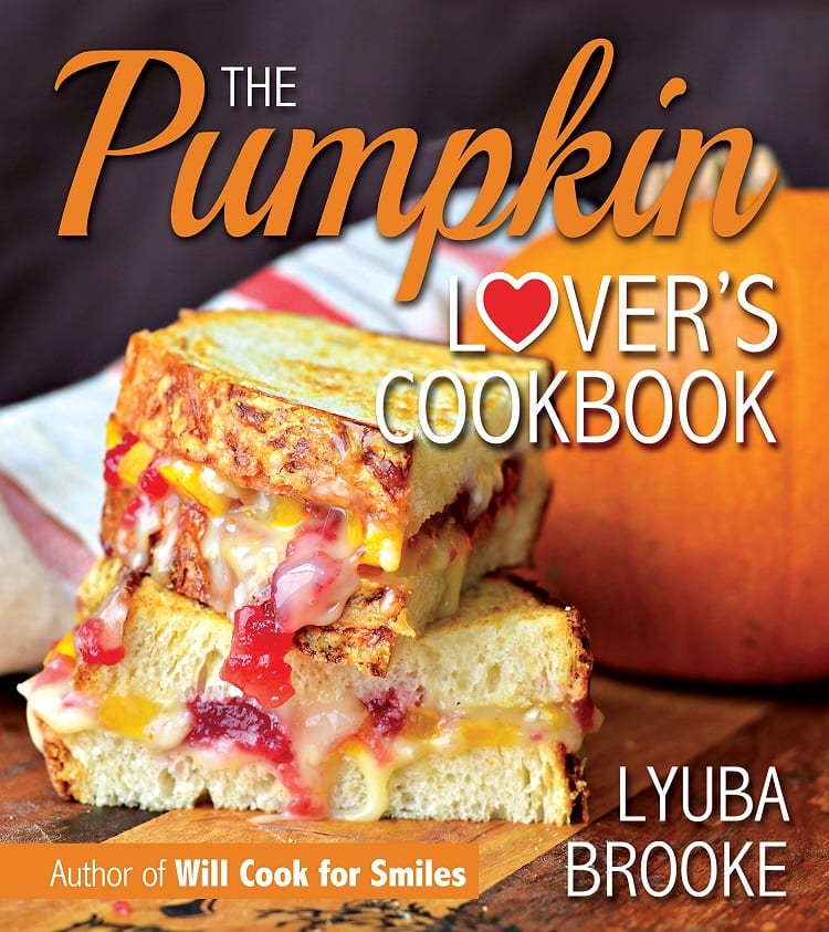 the pumpkin lovers cookbook with a sandwich on the cover with pumpkin and cranberry cut in half 