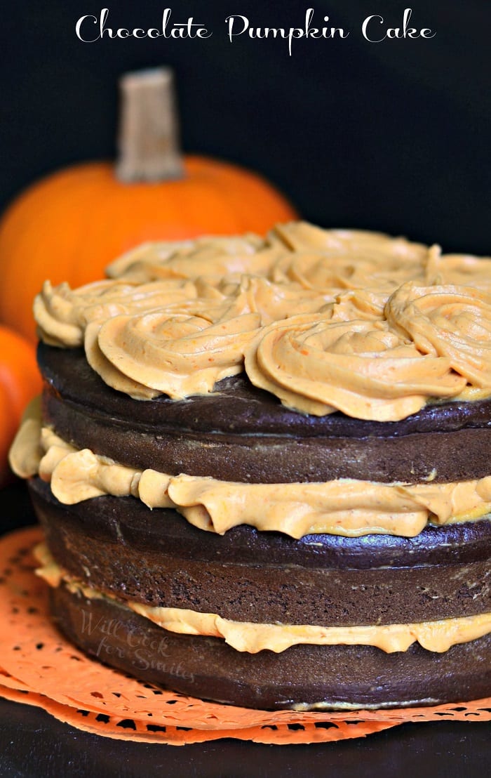 Chocolate Cake layers with Pumpkin Cream Cheese Frosting with pumpkin in the background