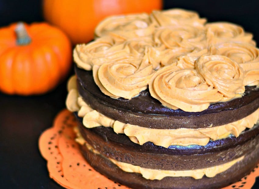 Chocolate Cake layers with Pumpkin Cream Cheese Frosting with  pumpkin in the background