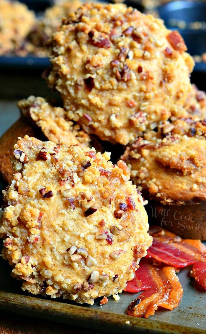 Maple Bacon Streusel Muffins stacked up with bacon around it 