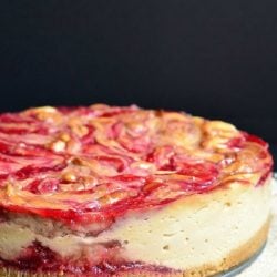 picture of whole peanut butter and jelly cheesecake on a white cloth while all sit on a black table