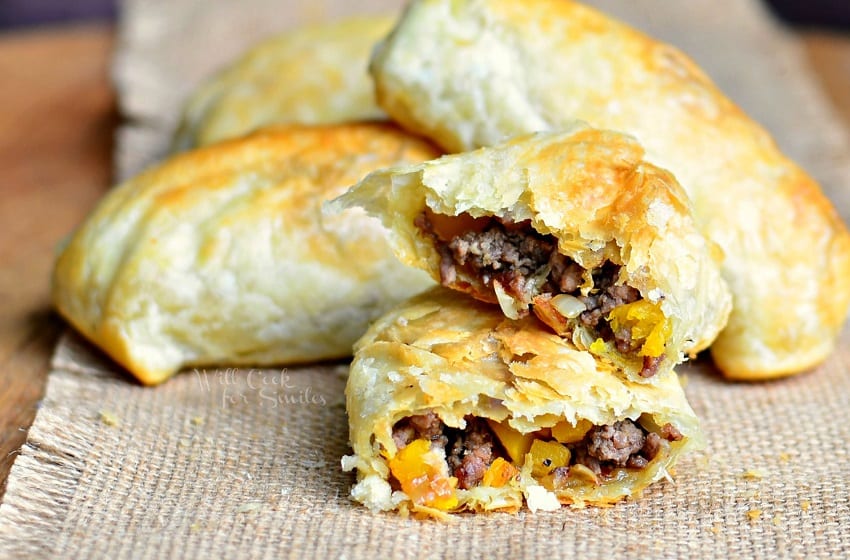 Hand Pies with beef and onions in side with one cut in half 