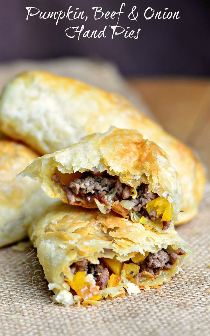 Hand Pies with beef and onions in side with one cut in half 