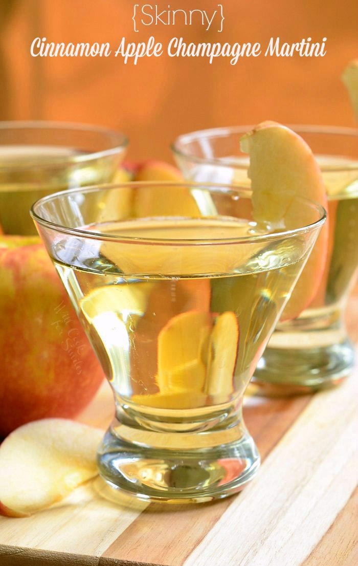 {Skinny} Cinnamon Apple Champagne Martinis in short martini glasses with a sliced apple placed on the rim of the glass.