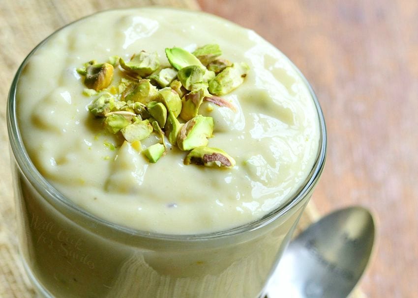 top view of Pistachio Pudding with chopped up pistachios on top in a clear glass bowl 