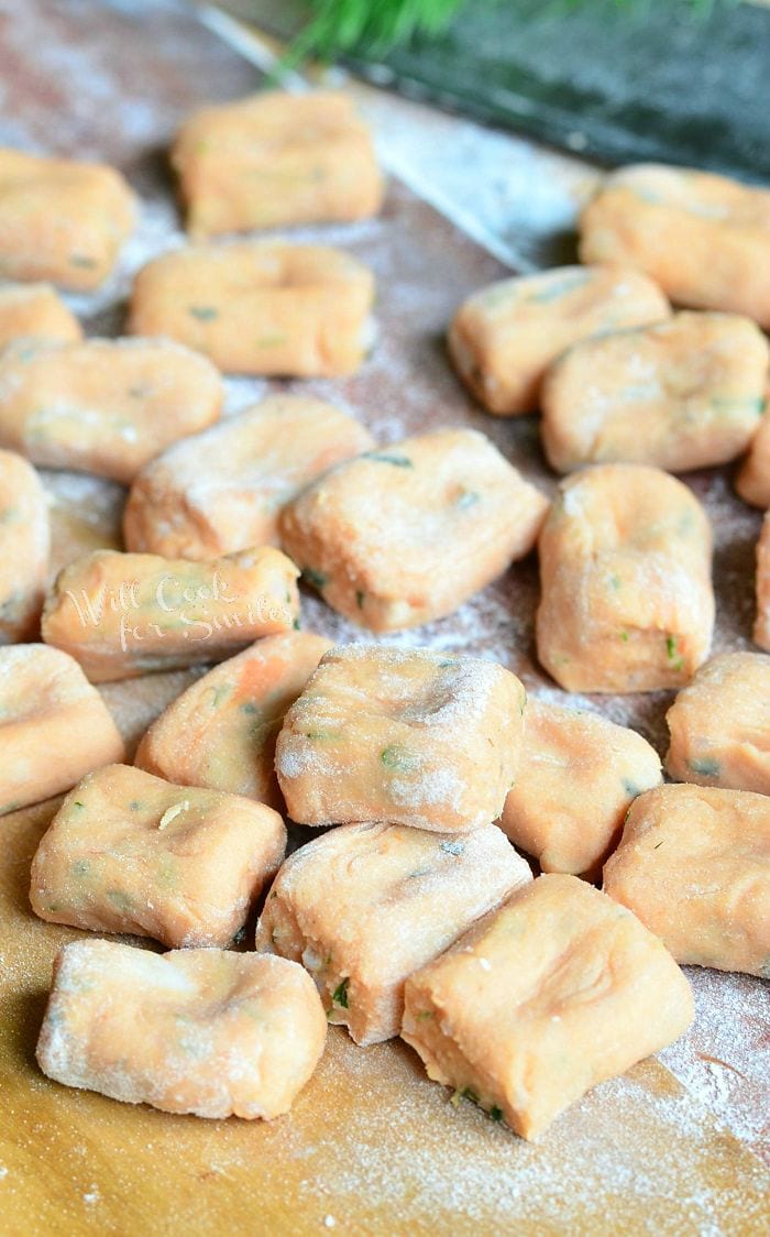 uncooked Tomato Herb Gnocchi on a cutting board 