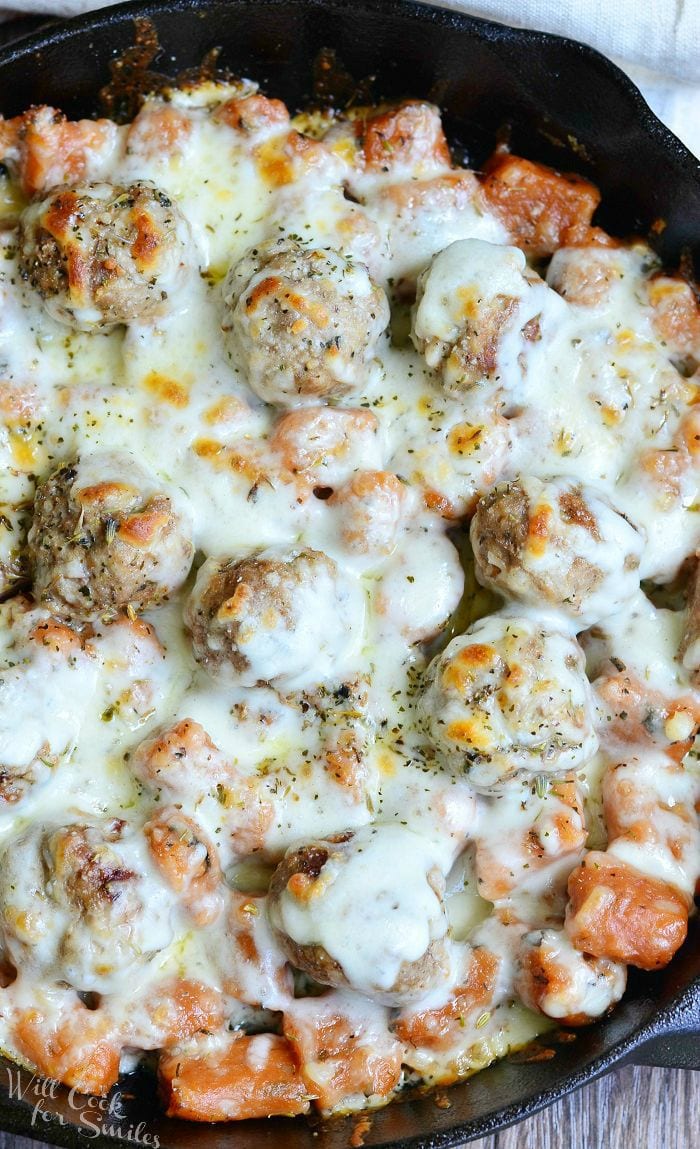 top view photo of Meatball and Gnocchi Bake with cheese on top in a cast iron skillet 