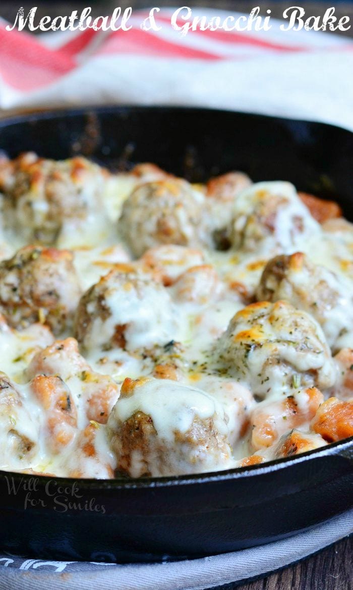 Meatball and Gnocchi Bake with cheese on top in a cast iron skillet 