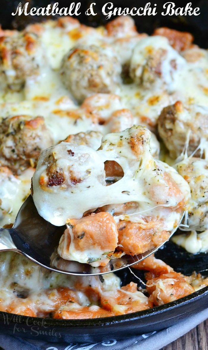 Meatball and Gnocchi Bake with cheese on top on a cast iron skillet 