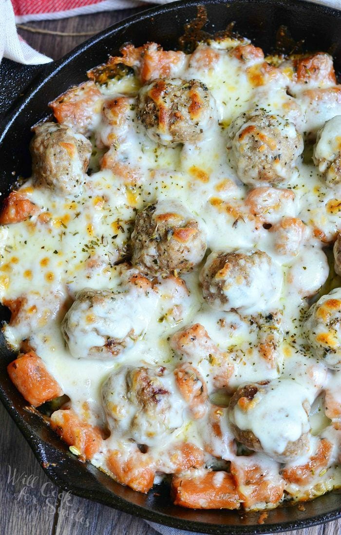 top view photo of Meatball and Gnocchi Bake with cheese on top in a cast iron skillet 