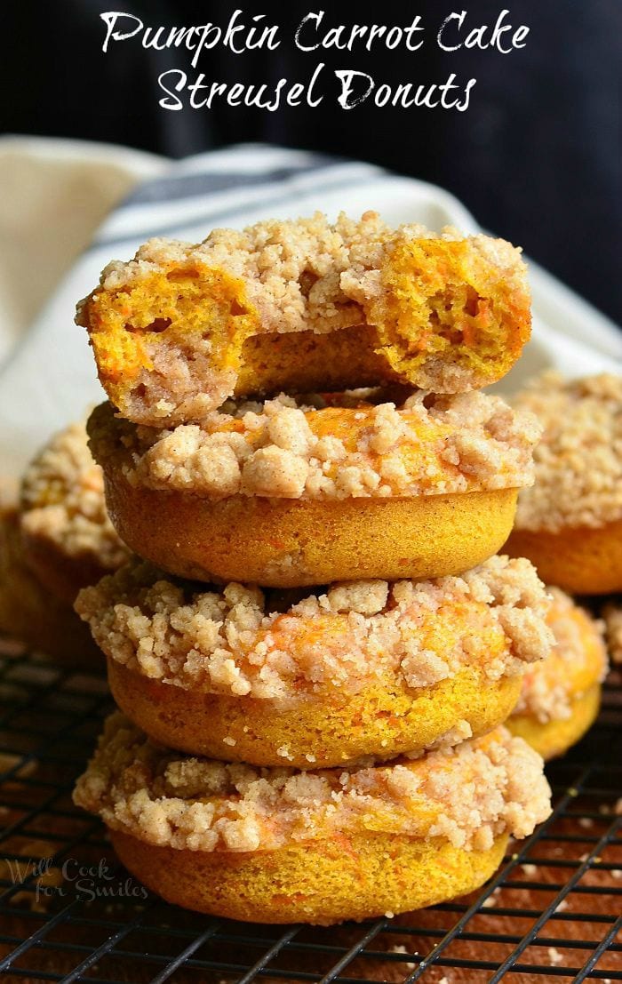 Pumpkin Carrot Cake Streusel Donuts staked up on a cutting board 