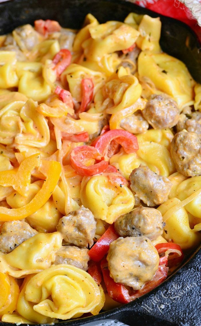 top view of sausage, Peppers, and Onion Tortellini in a cast iron skillet 