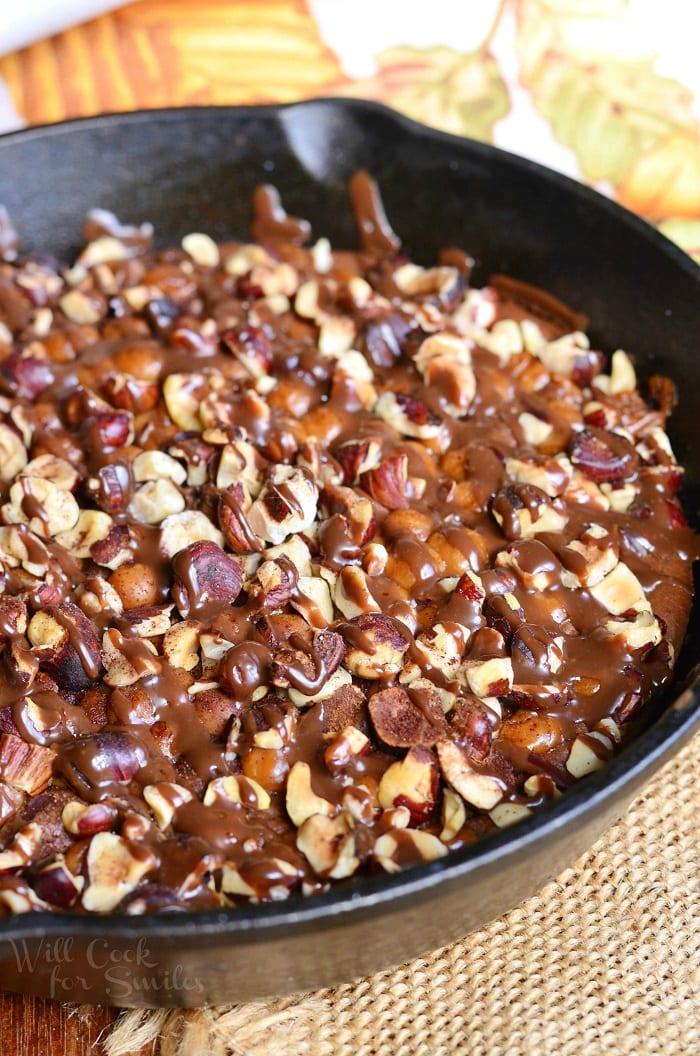 Small Batch Pumpkin Turtle Brownie in a cast iron skillet with nuts and caramel on top 