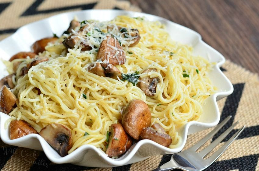 Truffle Pasta and Mushrooms in a white serving bowl with a fork to the right