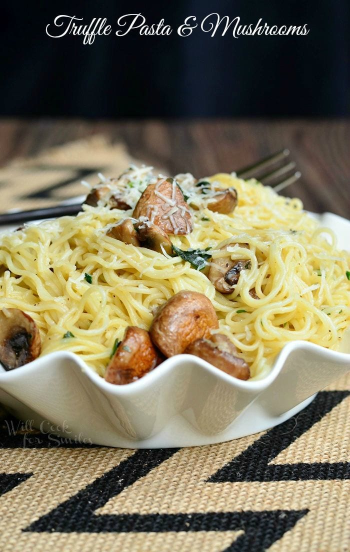 Truffle Pasta and Mushrooms in a white serving bowl with a fork to the left 