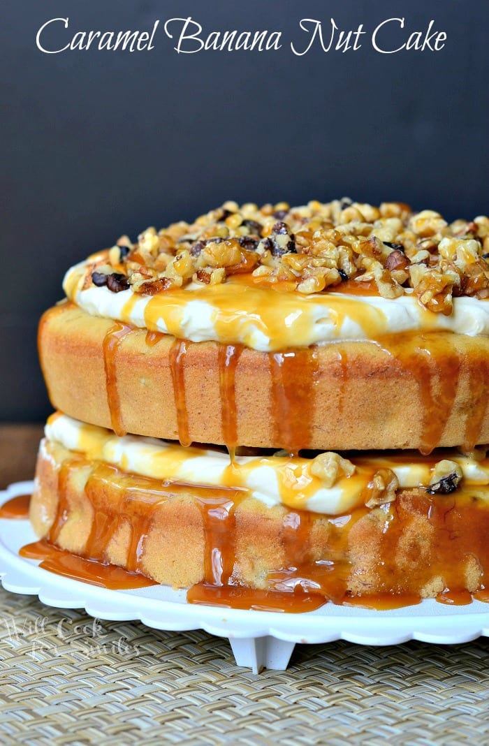 Caramel Banana Nut Cake on a cake platter with nuts and caramel over the top 