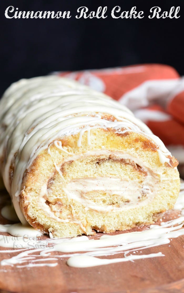 Cinnamon Roll Cake Roll with icing on top on a plate 