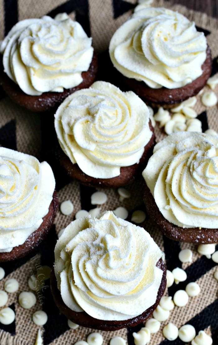 top view photo of Double Chocolate Cupcakes with cream cheese cupcakes on a table with white chocolate chips around the it 