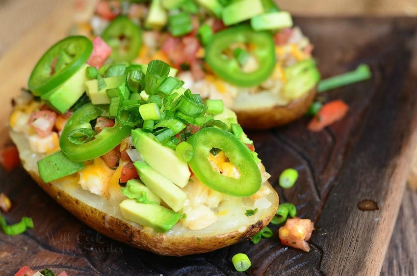 Twice Baked Potatoes with cheese, green onions, jalapenos, and avocado 