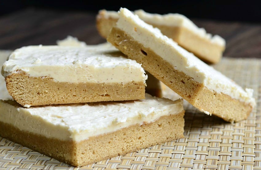 Frosted Maple Cookie Bars stacked up on placemat 