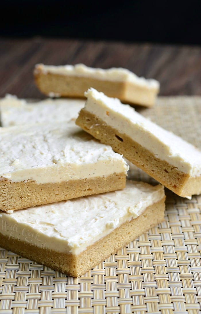 Frosted Maple Cookie Bars stacked up on placemat 