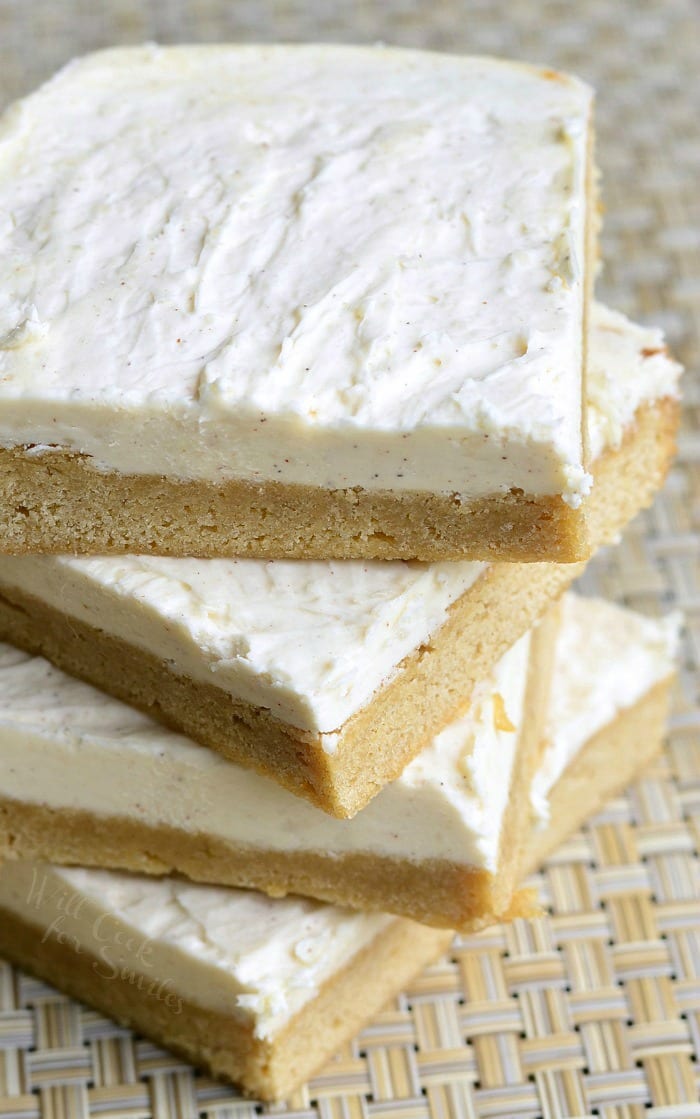 Frosted Maple Cookie Bars stacked up on placemat 