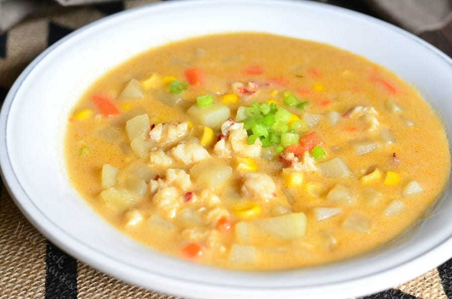 Lobster, Potato and Corn Chowder in a bowl with a spoon scooping some out 