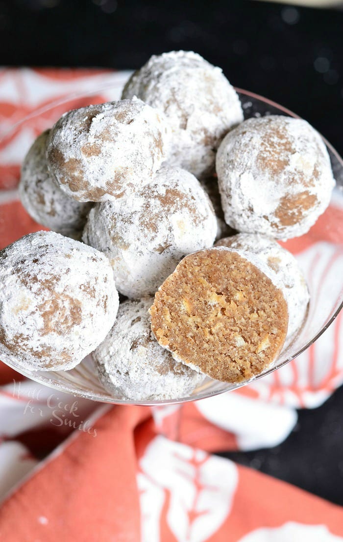 Pumpkin Spice Rum Balls with powder sugar on the outside of them in a champagne glass 