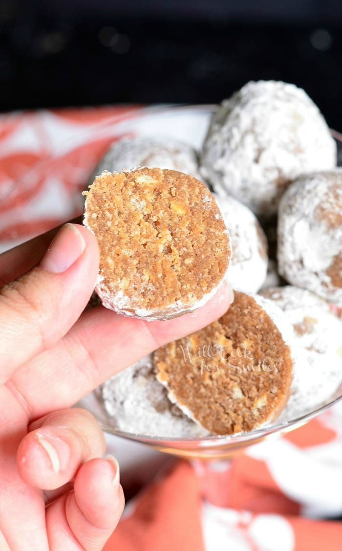 holding a Pumpkin Spice Rum Ball that has been cut in half 