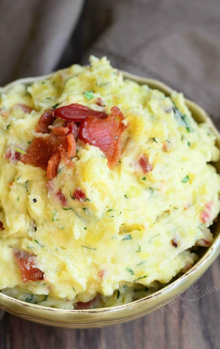 top view Mashed Potatoes with bacon and herbs mixed in and bacon on top  in a bowl 