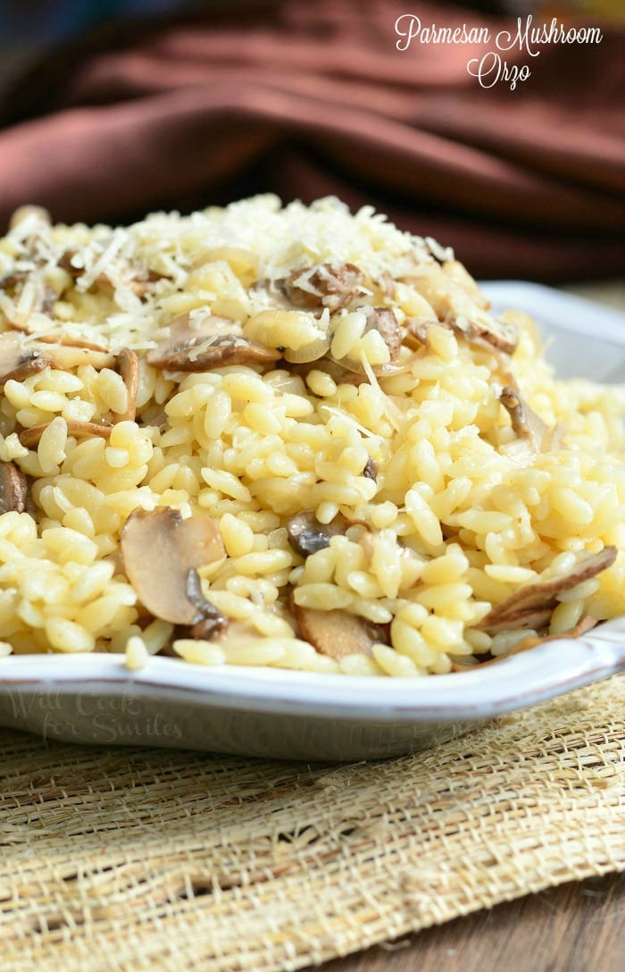 Parmesan Mushroom Orzo in a serving bowl on a wood table with a table cloth