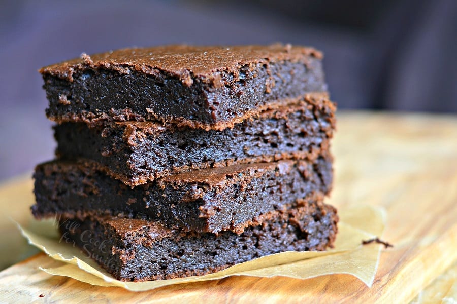 Pumpkin Brownies stacked up on parchment paper 