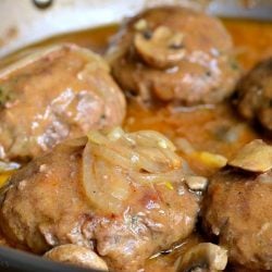 close up view of a saute pan with cooked salisbury steak