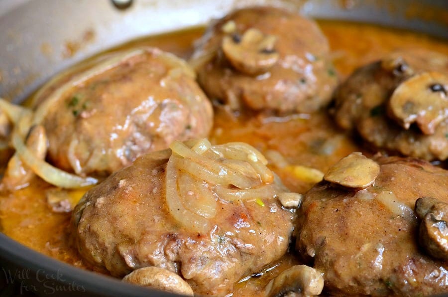 cooked Salisbury Steak with gravy in a pan 
