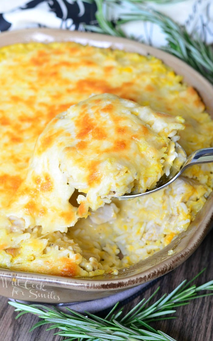 Turkey, Butternut Squash, and Mascarpone Rice Casserole in a baking dish with a spoon scooping some out