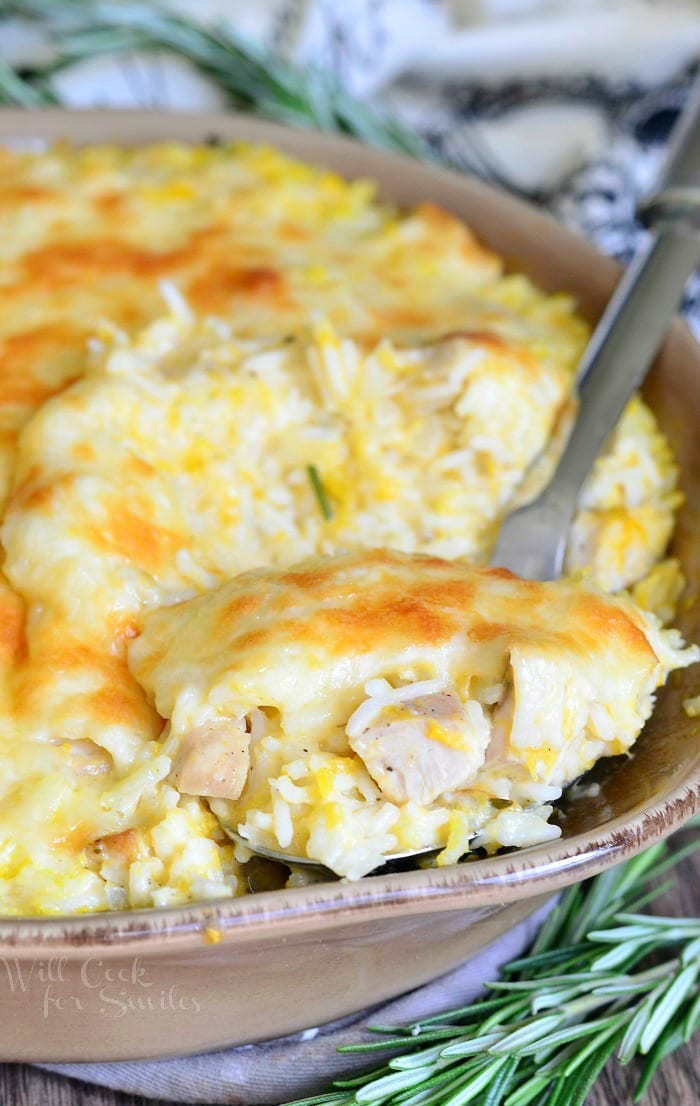 Turkey, Butternut Squash and Mascarpone Rice Casserole in a casserole dish with a spoon scooping some out