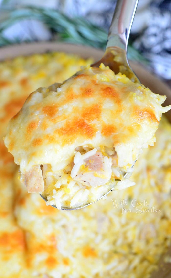 Turkey, Butternut Squash and Mascarpone Rice Casserole in a casserole dish with a spoon scooping some out 