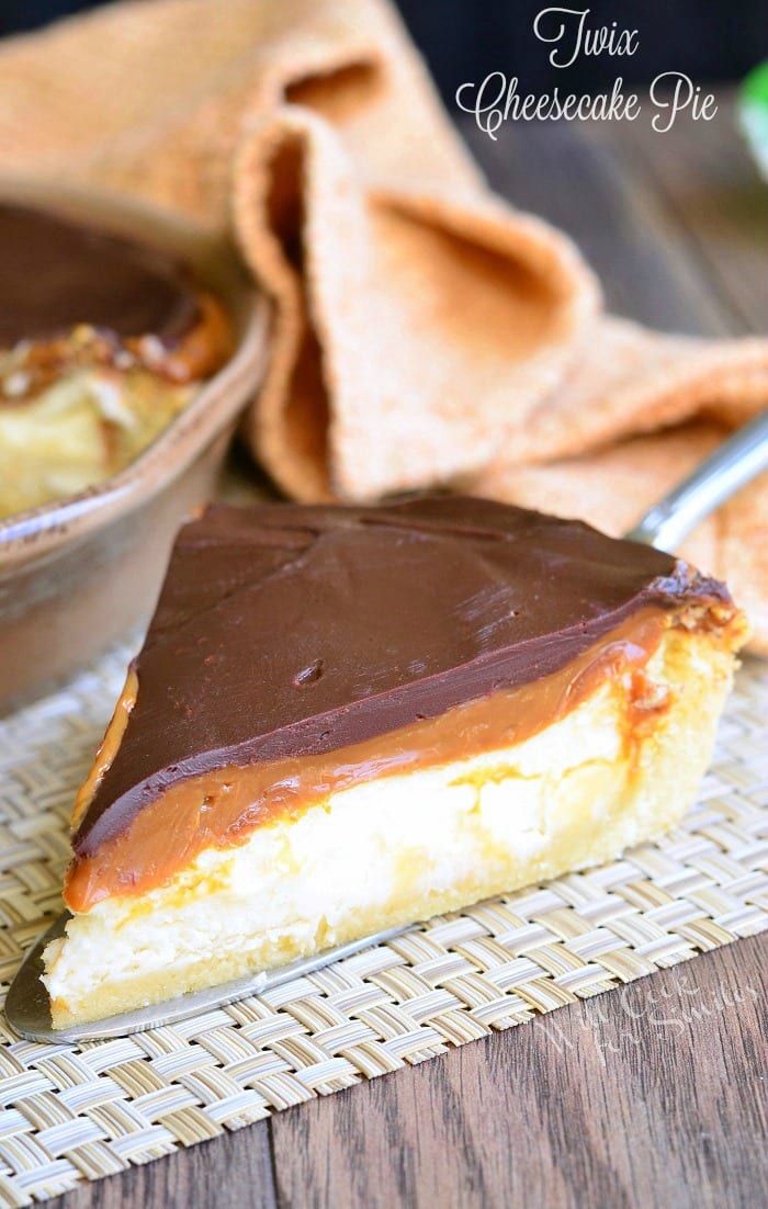 Twix Cheesecake Pie on a placemat with a pie spatula under it