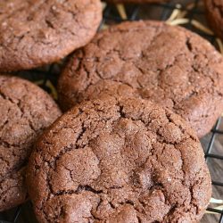 2 chocolate chocolate chip gingersnap cookies on a cooling rack