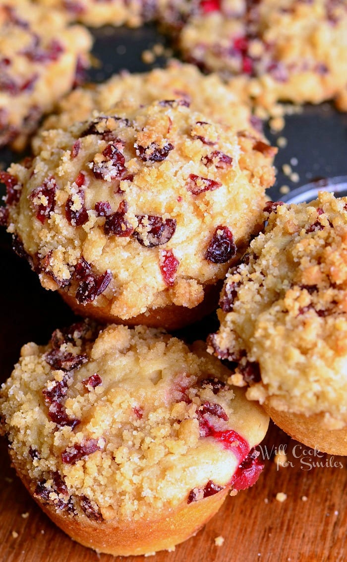 Cranberry White Chocolate Chip Streusel Muffins stacked up on a muffin pan 