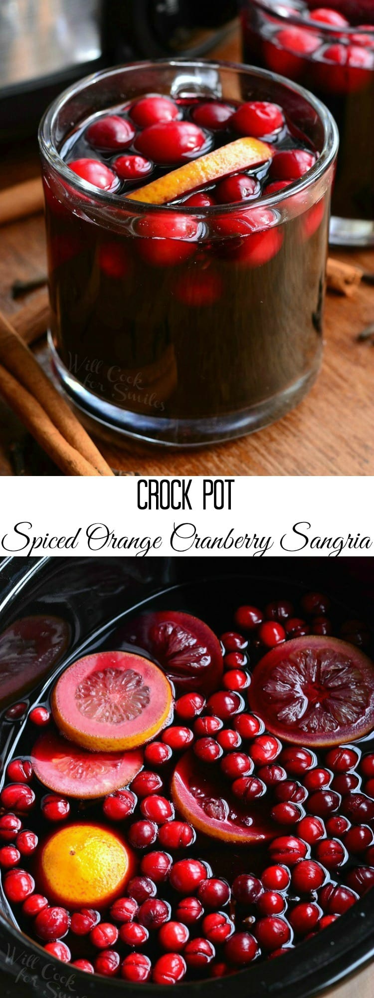 holding Orange Cranberry Sangria in a glass mug with orange and cranberries inside 