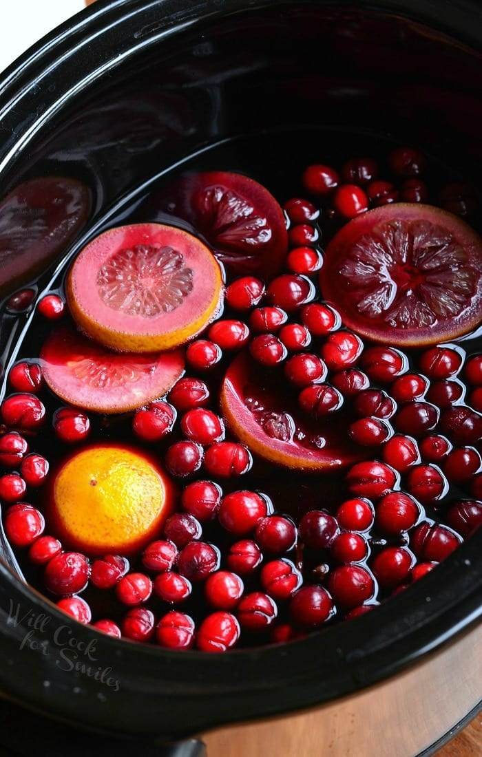 Orange Cranberry Sangria in a crockpot with oranges and cranberry 