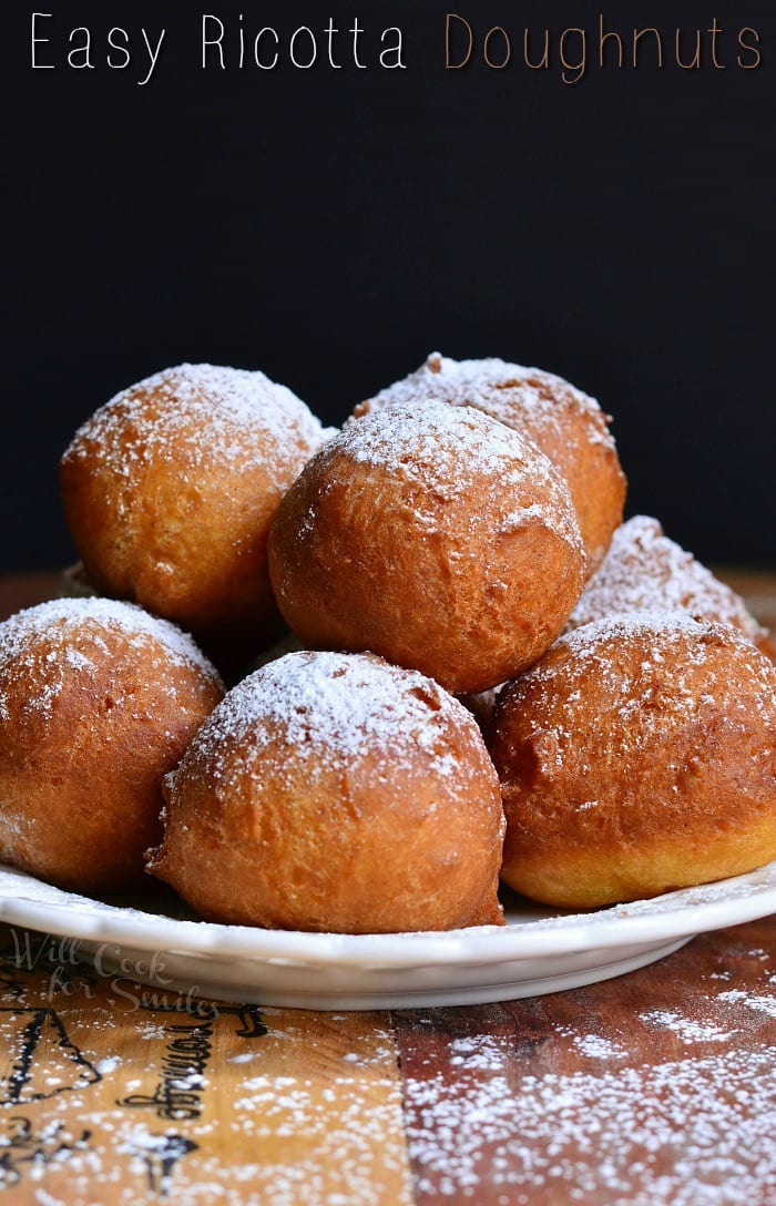 Ricotta Doughnuts stacked up on a white plate 